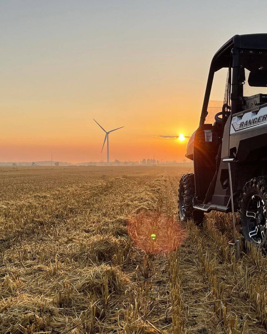 One of Holmes Agromart's vehicles on the field at sunset.