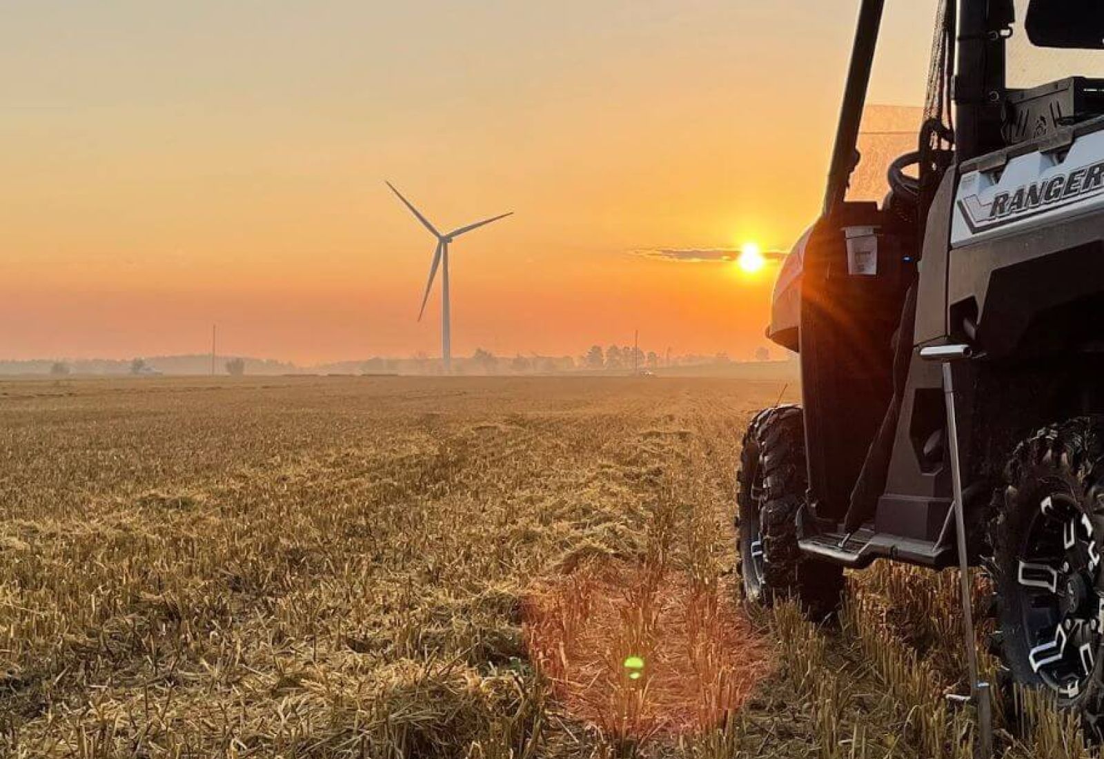 One of Holmes Agromart's vehicles on the field at sunset.