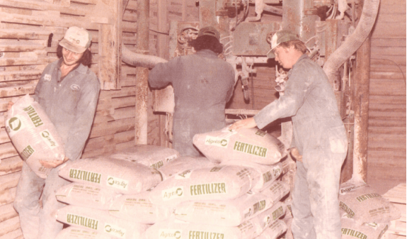 Holmes Agro employees with fertilizer