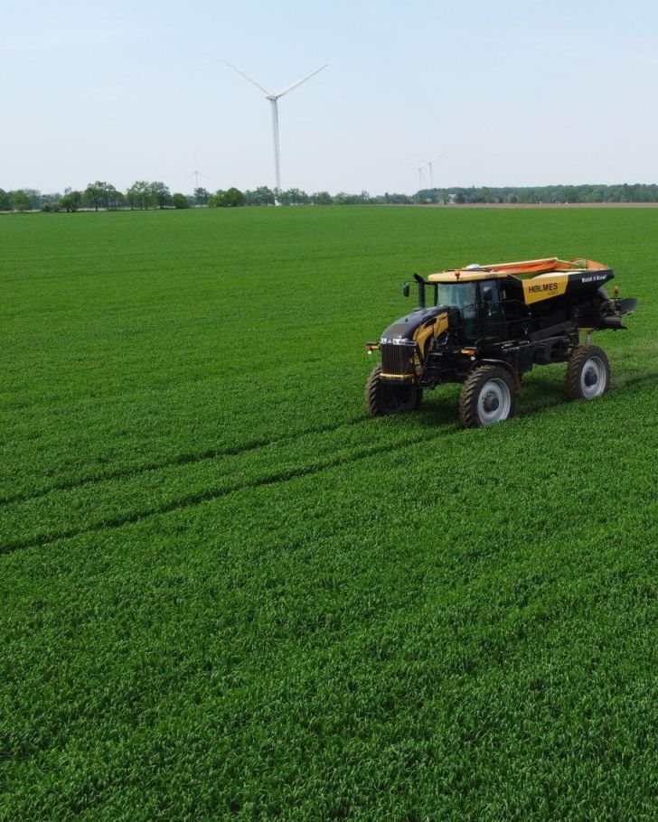 Holmes Agro equipment on crop with blue sky in the background