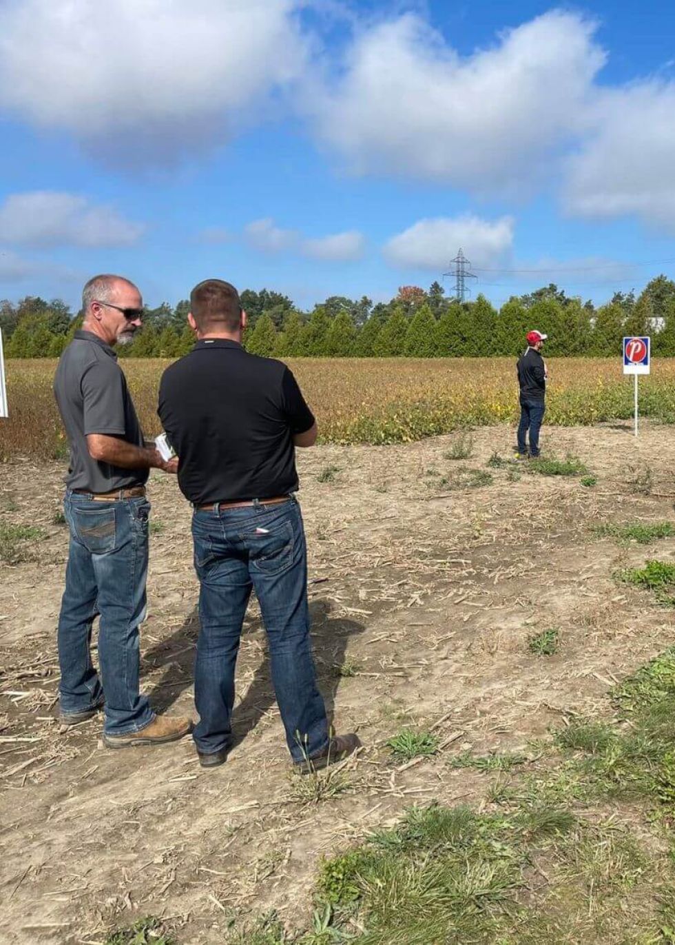 Agronomists on the field discussing strategy.